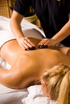 woman at a day spa getting a lastone massage