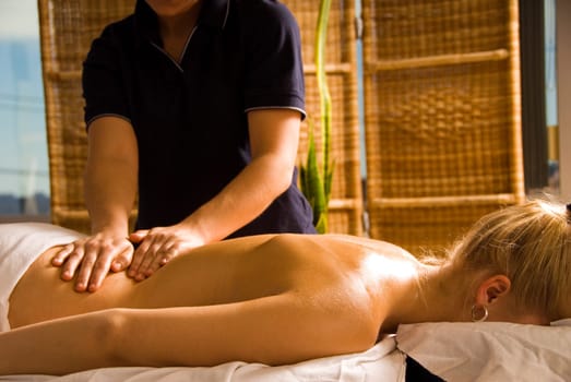 woman at a day spa getting a nice back massage
