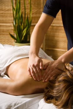 woman in a day spa getting a neck massage