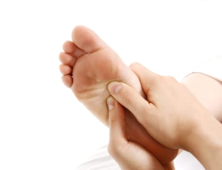 a foot massage given by a therapist in a spa