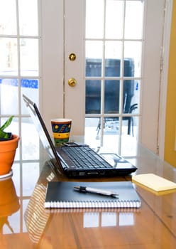 laptop, blackberry and pen on the table