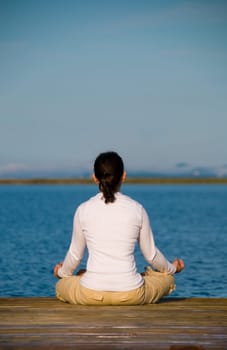Yoga Woman on a dock by the ocean