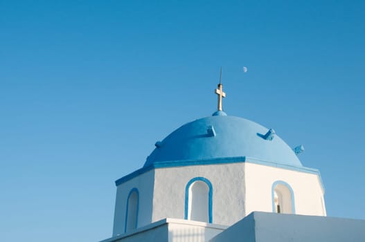 Greek church in santorini greece with a cross