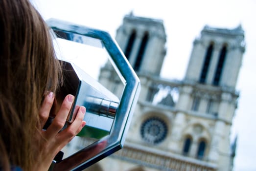 a female tourist looking at the notre dame basilica