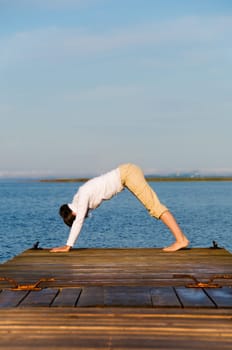 Yoga Woman on a dock by the ocean