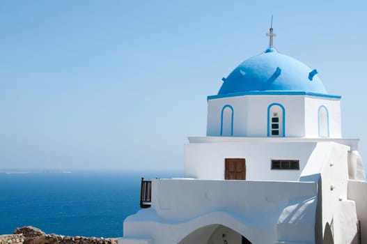 Greek church in santorini greece with a cross