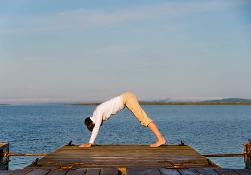 Yoga Woman on a dock by the ocean