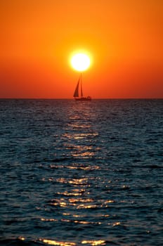 Sunset colors over the ocean sea sail boat
