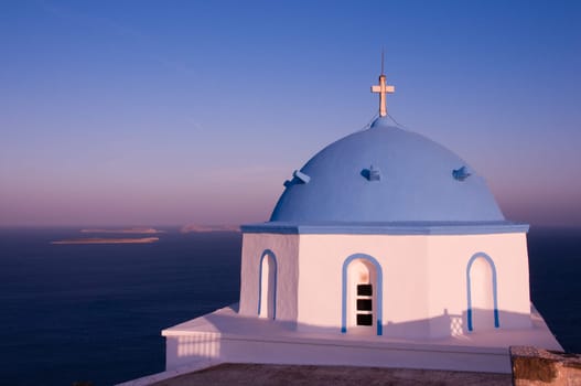 Greek church in santorini greece with a cross