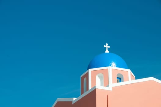 Greek church in santorini greece with a cross