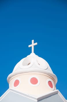 Greek church in santorini greece with a cross