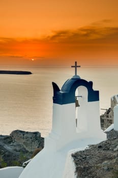 Greek church in santorini greece with a cross
