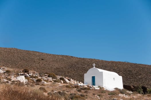 Greek church in santorini greece with a cross