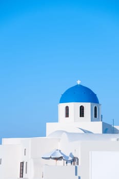 Greek church in santorini greece with a cross