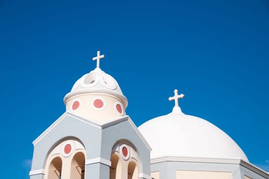 Greek church in santorini greece with a cross