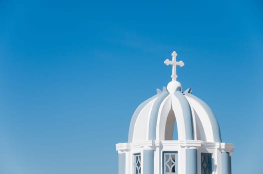 Greek church in santorini greece with a cross