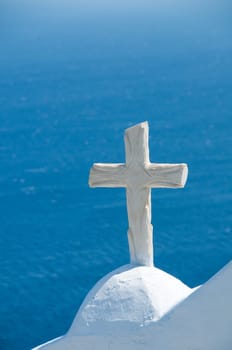 Greek church in santorini greece with a cross