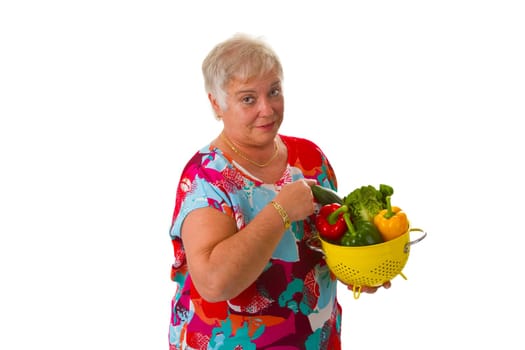 Senior woman with fresh vegetables - isolated on white background