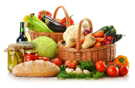 Composition with wicker basket and grocery isolated on white