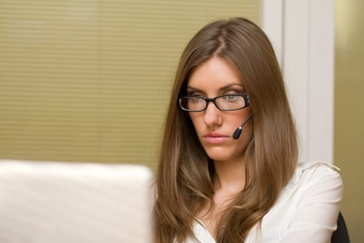 Photo of charming consultant with microphone sitting in office