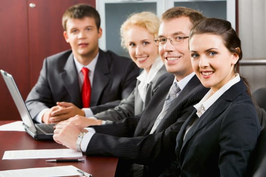 Four confident specialists gathered together for discussion of new strategy of business