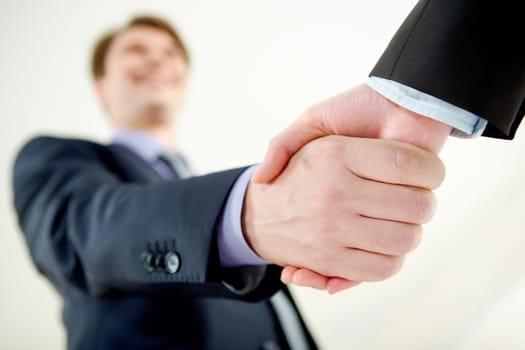 Image of handshaking of business partners on signing agreement