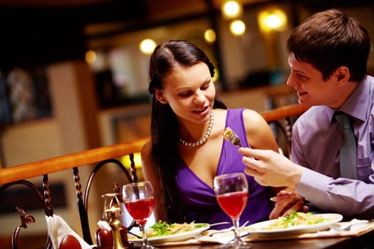 Photo of man proposing meal to his girlfriend