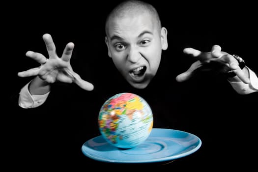 Furious man screaming while trying to capture earth rotating on blue saucer