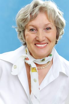 Portrait of happy elderly female looking at camera
