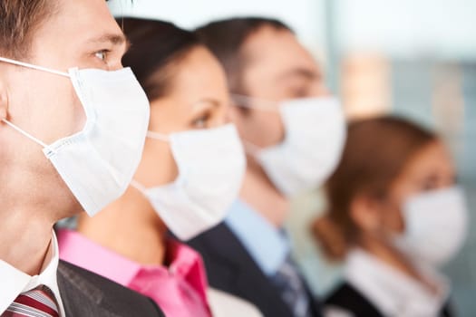 Portrait of businessman in protective mask with line of people on background