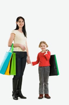 Portrait of mother and daughter with paperbags after shopping