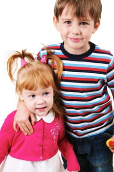 Portrait of smiling boy looking at camera while embracing his sister