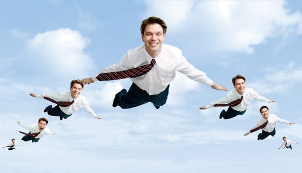 Conceptual image of many businessmen flying in the clouds