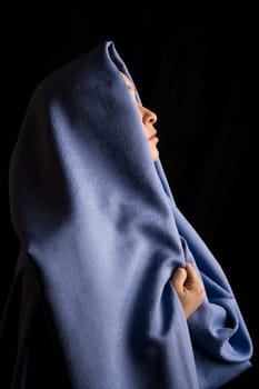 Image of moslem woman with blue fabric on her head