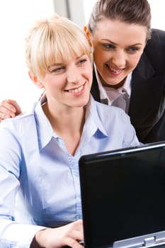 Portrait of two young business women working together