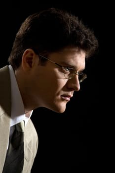 Portrait of serious male in suit over black background