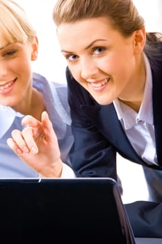 Portrait of beautiful assistant looking at camera during explanation of project to a new colleague