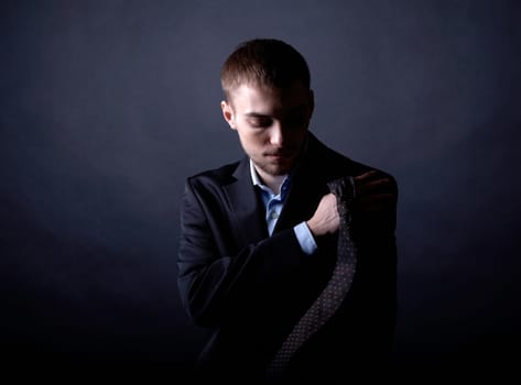 Portrait of serious businessman in darkness