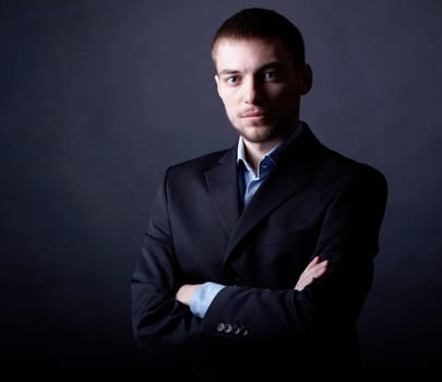 Portrait of serious businessman in darkness