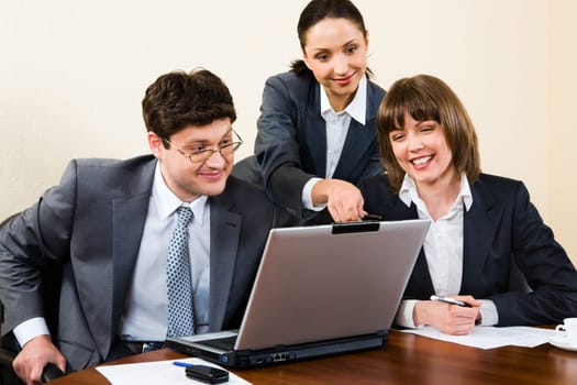 Business woman is explaining the correct way of analysis to her colleagues in  the office