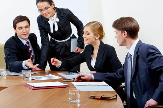 Portrait of confident co-workers discussing hottily new business plan at meeting