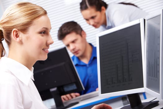 Image of secretary typing on the background of working people