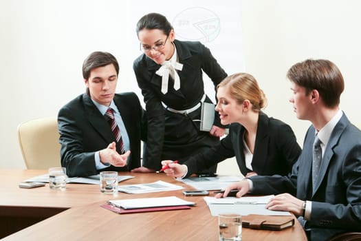 Portrait of confident co-workers discussing hottily new business plan at meeting
