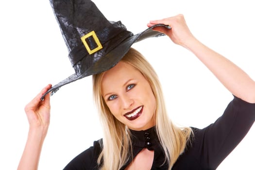 Portrait of young female putting off black hat and keeping it over head