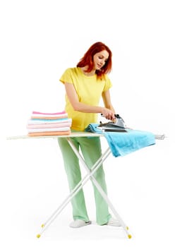 Portrait of young female ironing towels at home