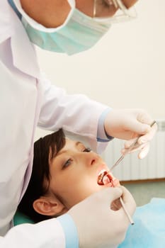 A dentist examining a girls teeth