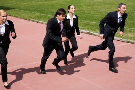 Image of employees running on sport track