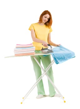 Portrait of young female ironing towels at home