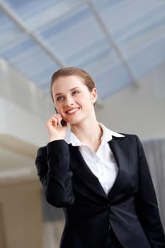 Photo of female employee speaking on the phone with smile