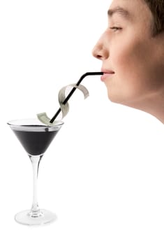 Profile of young man drinking oil through tubule from martini glass